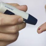 Person testing a small sample of blood on their finger